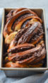 Loaf of chocolate babka in a bread pan.