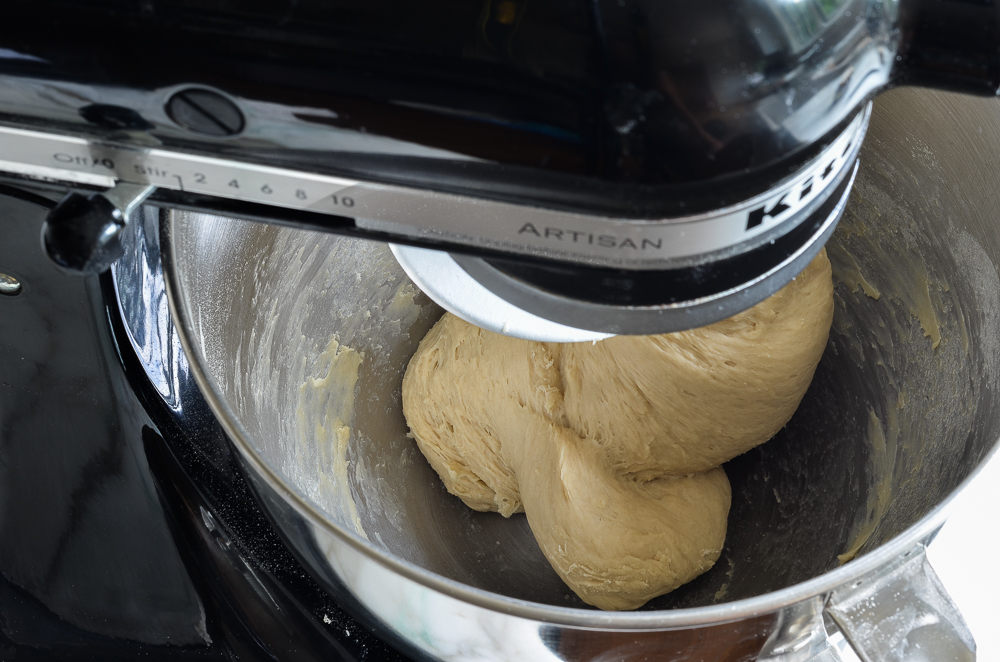 Pretzel dough in the bowl of a stand mixer.